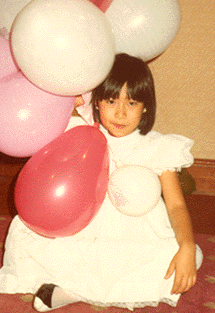 With balloons, aged seven